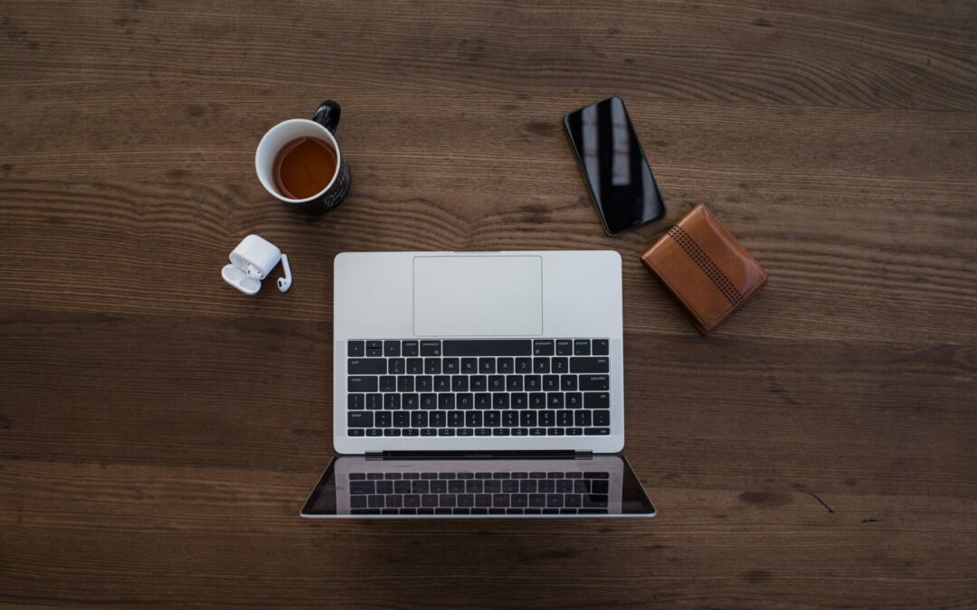 laptop with wallet and phone